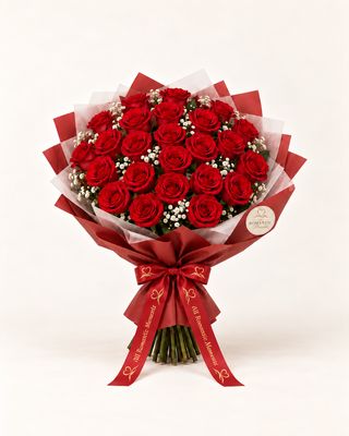 Red roses wrapped in translucent paper with a red satin bow.